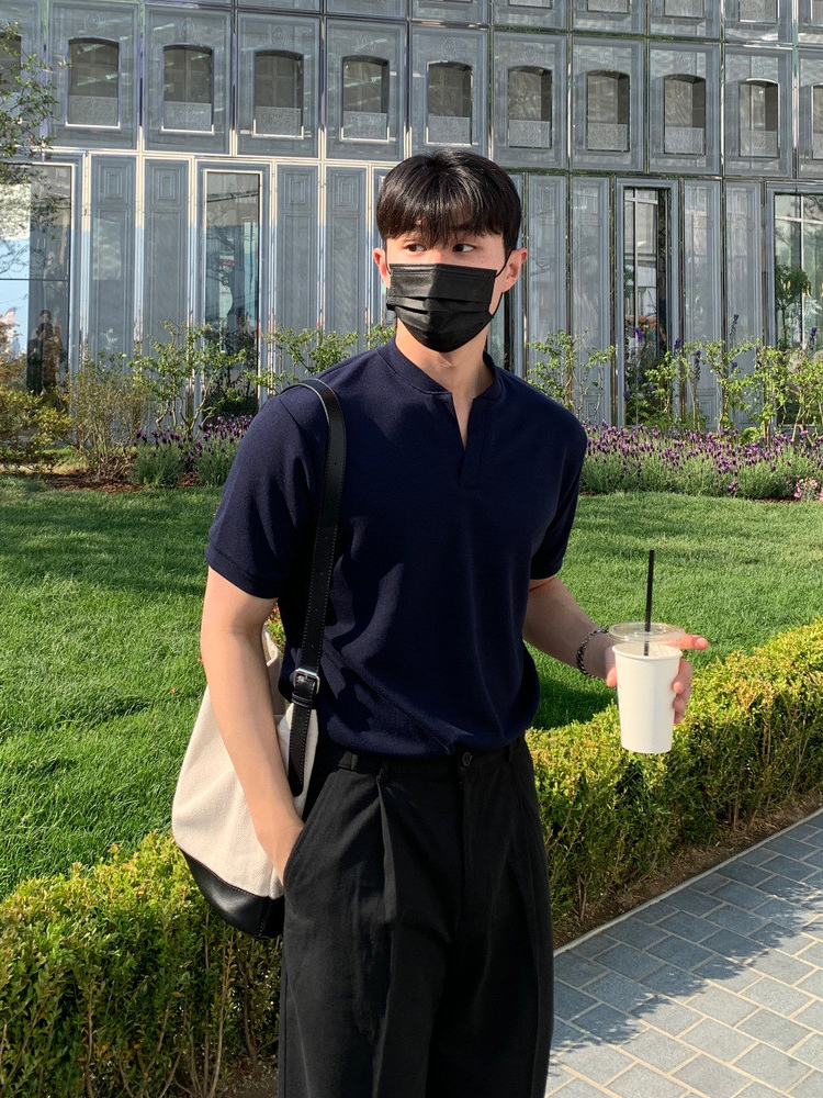 Jet-Black Mask + Navy Split-Neck Knit Polo + Canvas-Leather Two-Tone Tote + High-Rise Black Pleated Trousers