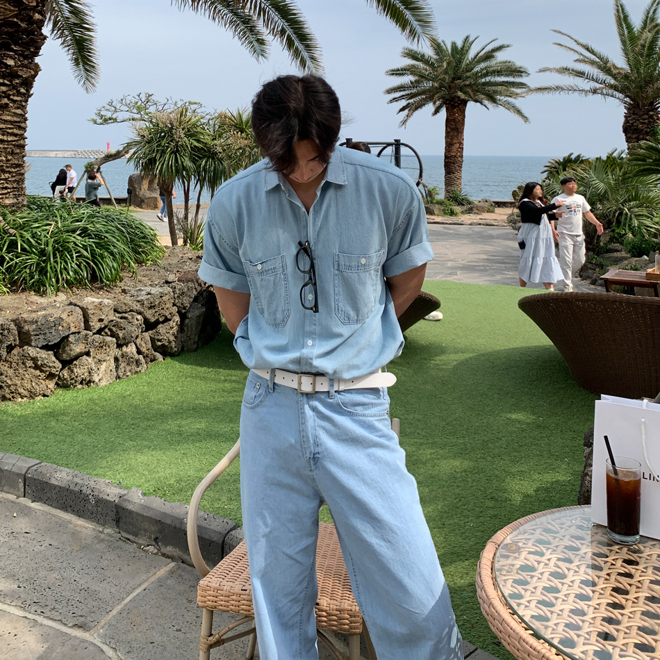 Tousled fringe + vintage sunglasses + washed denim short-sleeve shirt + white canvas belt + light-wash denim jeans