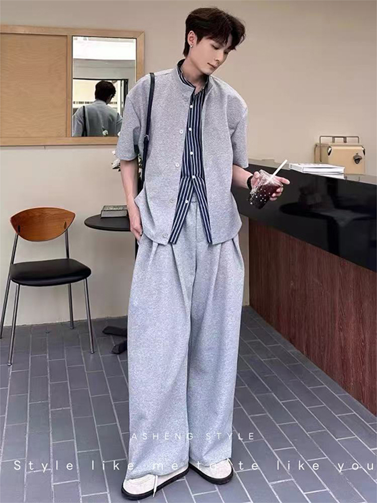 Textured fringe + cross-body strap + heather-grey knit shacket + navy striped poplin shirt + wide heather-grey trousers + off-white canvas loafers
