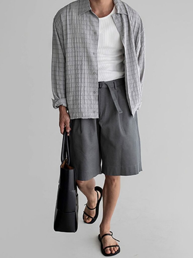 Cropped hair + Textured grey overshirt + White ribbed tank + Charcoal belted knee shorts + Black leather tote + Black strappy sandals
