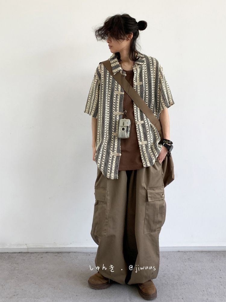 Messy Bun + Patterned Camp Shirt + Chocolate Crew Tee + Vintage Camera Strap + Cargo Balloon Pants + Brown Suede Work Boots
