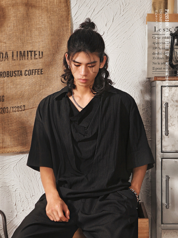Half-bun hair + silver chain + black draped collar shirt + relaxed black trousers