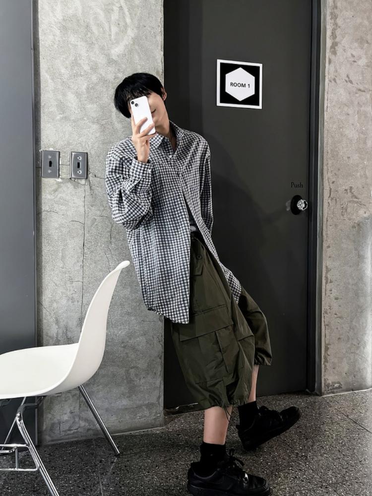 Bowl-cut fringe + gingham overshirt + olive cargo bermuda shorts + black crew socks + black sneakers