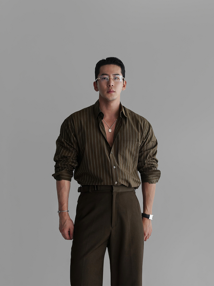 Crystal-rim glasses + Olive pinstripe open shirt + Square pendant + High-waist olive trousers + Pebble leather loafers