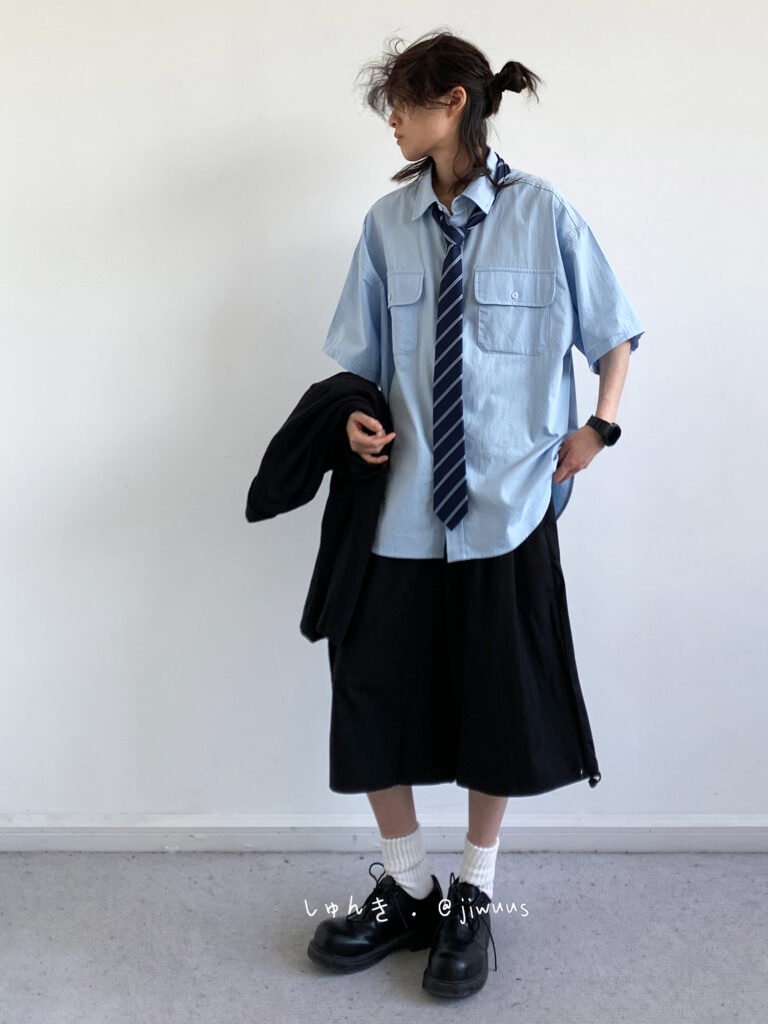 Messy twin-tail bun + Oversize sky-blue utility shirt + Loosened navy school tie + Black culotte shorts + White rib socks + Chunky derby shoes
