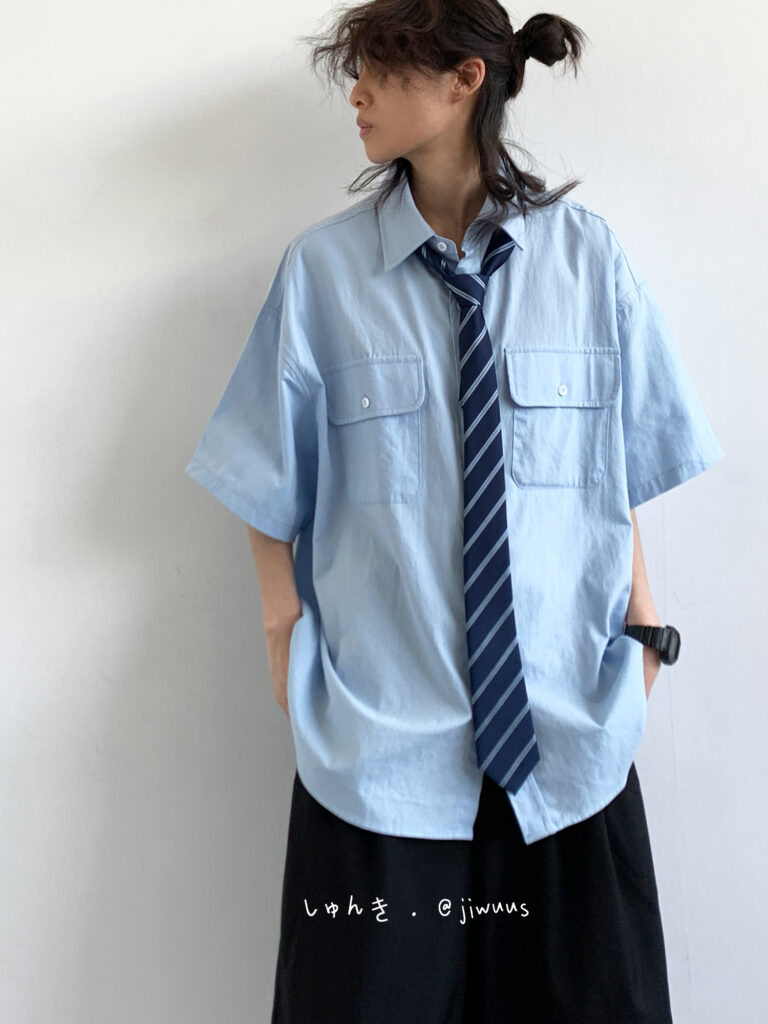 Messy up-knot + Sky-blue box-pocket shirt + Striped navy silk tie (loosely hung) + Black bishop culottes + Onyx field watch + Chunky derby shoes