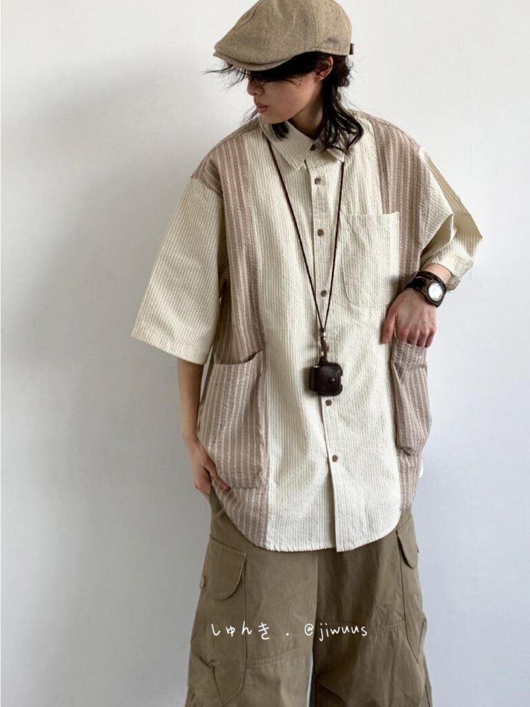 Linen newsboy cap + Patchwork corduroy camp shirt + Vintage camera lanyard + Khaki cargo wide pants + Mud-tone moc-toe boots