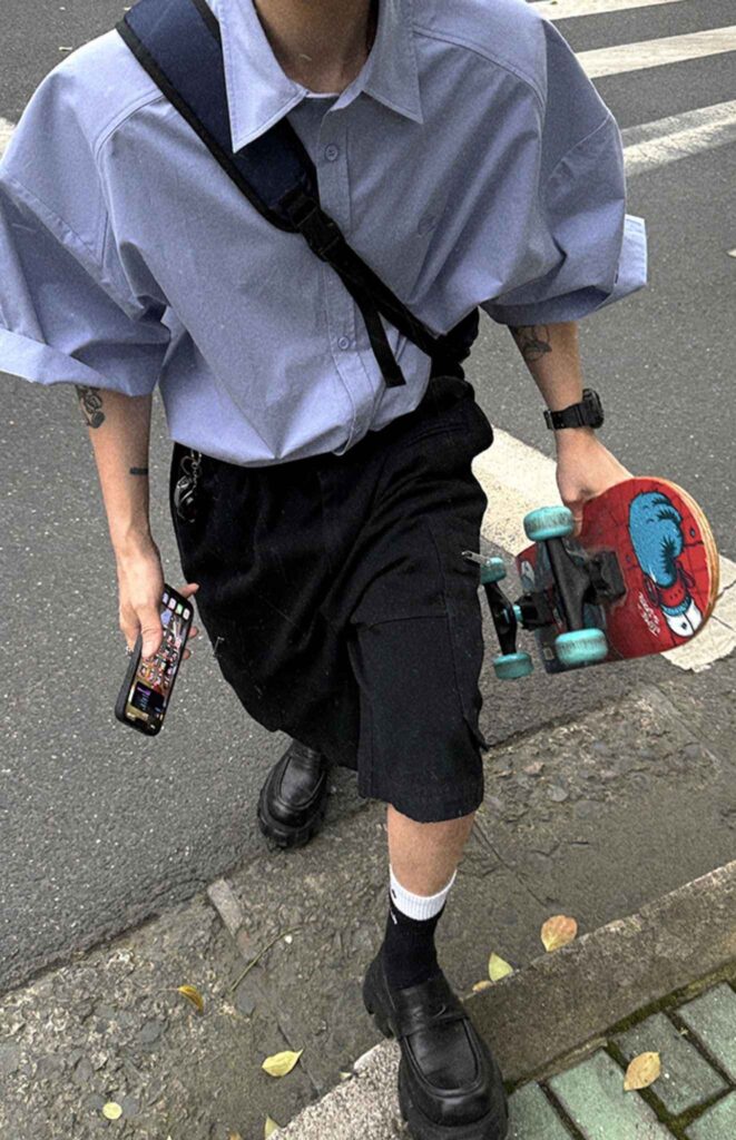 Stone slate cap + Cross-body safety strap + Periwinkle short-sleeve shirt + Black carve-pocket skate shorts + Digital skate watch + Modular skateboard loafers