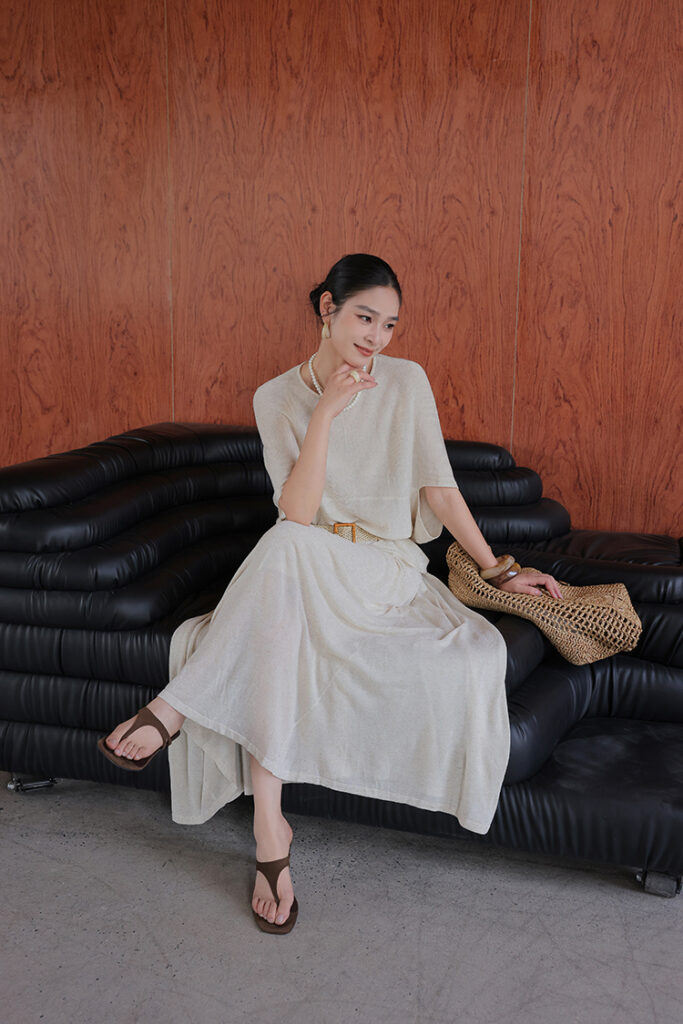 Sleek bun + beige poncho knit + belted beige midi skirt + brown sandals