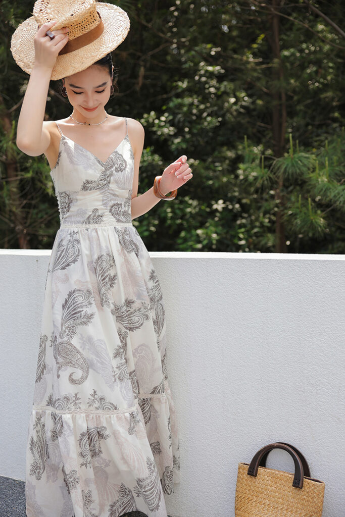 Straw boater hat + paisley spaghetti-strap maxi dress + resin bangle