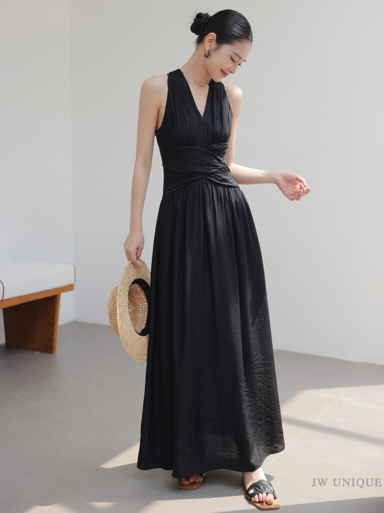 High bun + straw hat + black ruched halter maxi dress + black quilted slides