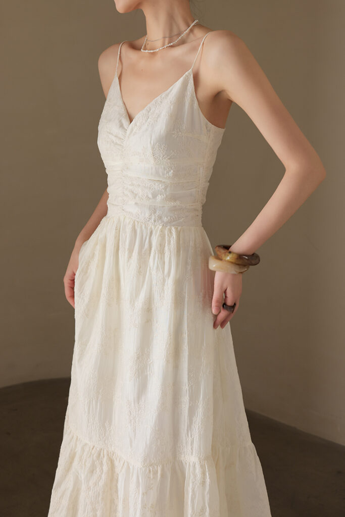 Strapless white column dress + woven leather-and-raffia tote + tan sandals