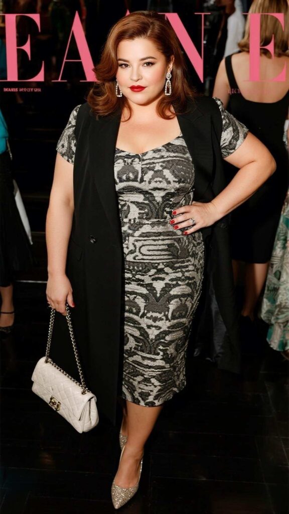 Side sweep + drop earrings + jacquard fit-and-flare dress + longline tuxedo vest + chain-strap shoulder bag + almond-toe pumps